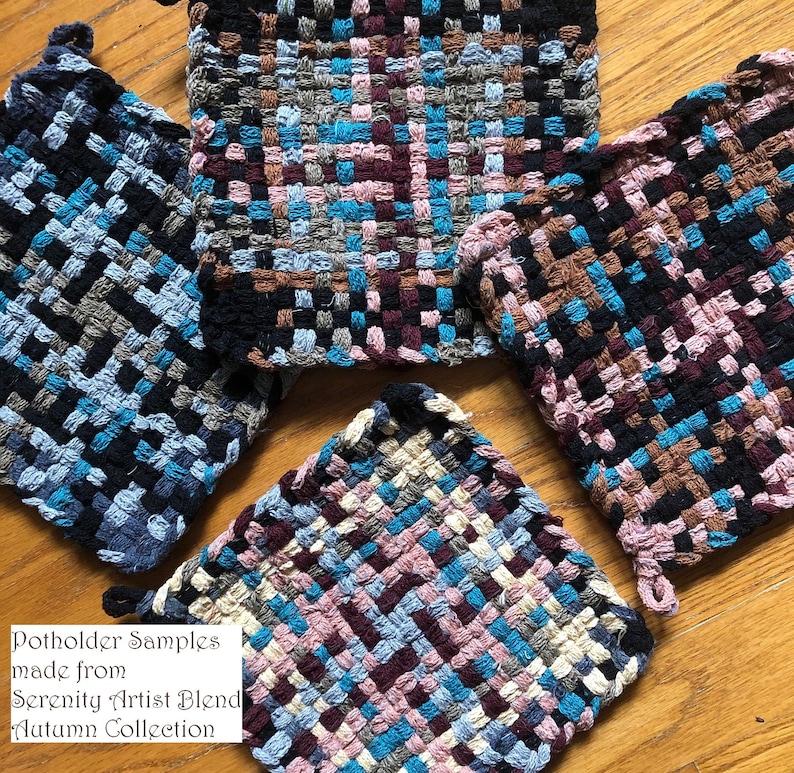 May include: Four woven pot holders in various colors, including black, brown, blue, pink, and cream. The pot holders are made from Serenity Artist Blend Autumn Collection yarn. The text "Potholder Samples made from Serenity Artist Blend Autumn Collection" is written on a white background.
