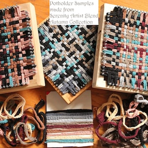 May include: Three wooden looms with woven potholders made from Serenity Artist Blend yarn in the Autumn Collection. The yarn is in various colors, including black, brown, teal, and pink. There are also loose strands of yarn in the same colors.