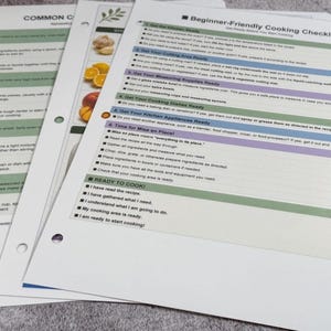 May include: A set of three laminated instructional sheets for cooking. The top sheet is titled Beginner-Friendly Cooking Checklist and includes numbered steps for kitchen preparation, mise en place, and a final ready to cook section with checkboxes.