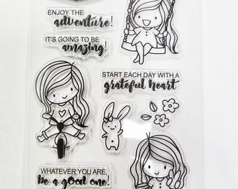 Little girls playing clear rubber stamps