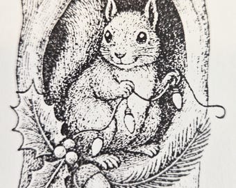 Squirrel hanging Christmas lights in tree rubber stamp