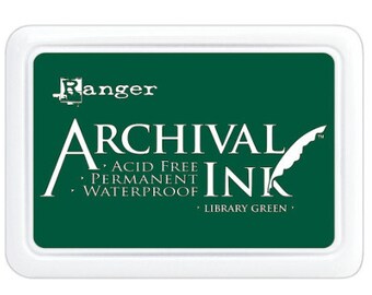 May include: A white ink pad with the words "Ranger Archival Ink" in white lettering on a dark green background. The ink pad is acid free, permanent, and waterproof. The ink pad is labeled "Library Green".