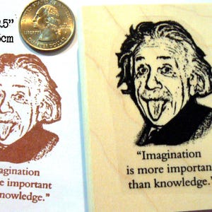May include: A wooden stamp featuring a black and white image of Albert Einstein sticking out his tongue. The stamp is 1.5 x 2.5 inches and includes the quote, "Imagination is more important than knowledge."