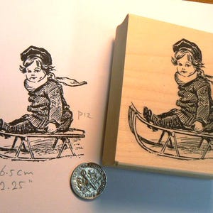 Boy on sled rubber stamp WM P12
