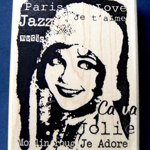 May include: Black and white illustration of a woman with a beret and the text "Paris Jazz Music Love Je t'aime Ca va Jolie Moulin Rouge Je Adore".