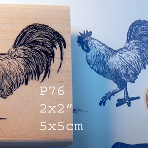 May include: A black and white rubber stamp of a rooster with the text 