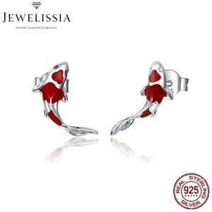 May include: A pair of sterling silver earrings featuring a red and white koi fish design. The earrings are marked "REAL 925 STERLING SILVER".