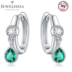 May include: A pair of sterling silver hoop earrings. Each earring features a clear, round gemstone at the top and a teardrop-shaped, emerald-green gemstone dangling below. The earrings are marked with "925 Silver". The brand name "JEWELISSIA" is at the top.