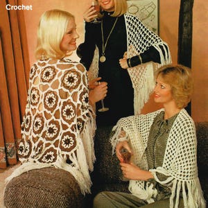 May include: Three women wearing crocheted shawls. The shawls are white and brown with floral patterns and fringe. The word "Crochet" is in the upper left corner. The women are holding glasses of wine.