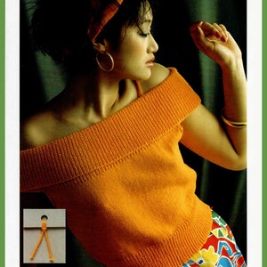 May include: A woman wearing an orange off-the-shoulder knitted top with a colorful patterned skirt.