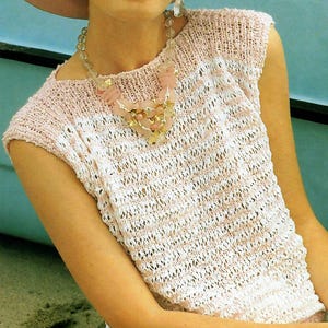 May include: A pink and white striped knitted sleeveless top with a beaded necklace.