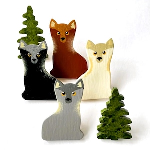 May include: Wooden figurines of wolves and evergreen trees. The wolves are painted in various colors: black, brown, gray, and cream. The trees are green. The figurines are likely for decorative purposes or a children's toy.