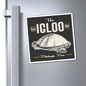 May include: A square refrigerator magnet featuring a dark gray background with a white line drawing of the Pittsburgh Civic Arena. The text reads The IGLOO, Estd 1967, and Pittsburgh, Penn, with yellow horizontal lines accenting the design.