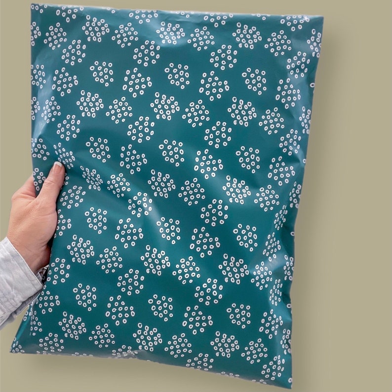 May include: Teal blue poly mailer with a white polka dot pattern. The mailer is made of a durable, water-resistant material.