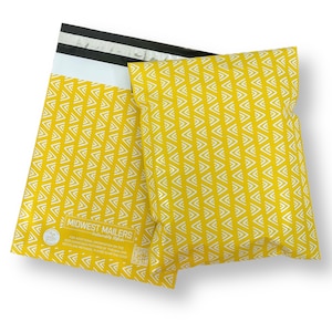 May include: Two yellow mailing envelopes with a white geometric pattern. The envelopes have a self-sealing strip and a black stripe across the top. The text "MIDWEST MAILERS" is printed on one envelope.
