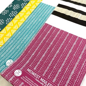 May include: A stack of colourful patterned mailing envelopes with the text "Midwest Mailers Sustainably Stylish" and a QR code. The text below the logo reads "For additional information on the eco-conscious features of this bag and recycling methods, please scan the code!"