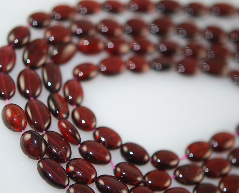 12 strands of 6mm smooth garnet ovals