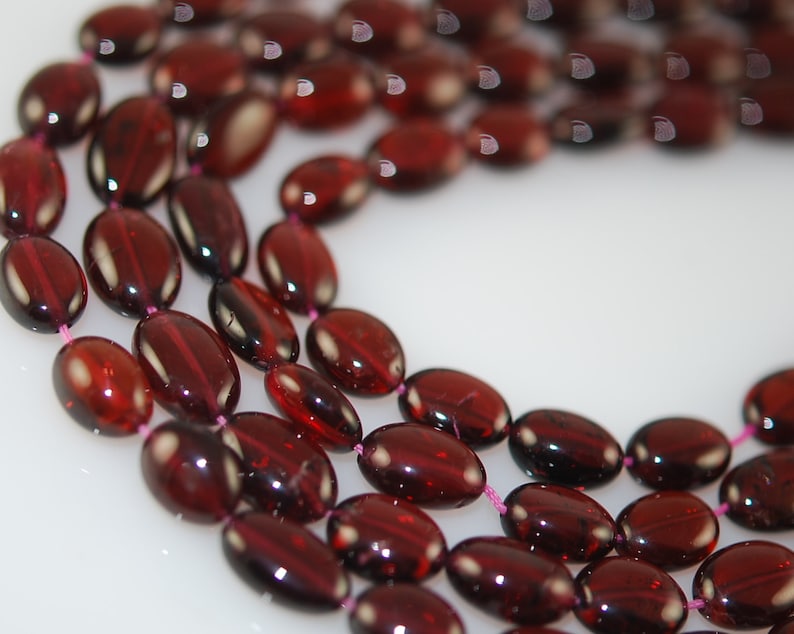 12 strands of 6mm smooth garnet ovals