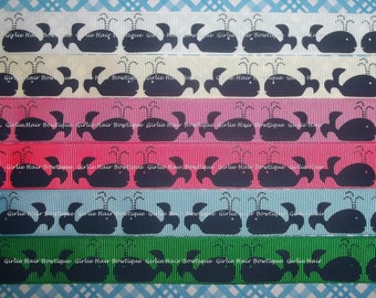 May include: A close-up of ten spools of ribbon with a whale design. The ribbon is in various colors, including white, cream, pink, red, light blue, green, and dark blue. The whales are black and have a water spout design.