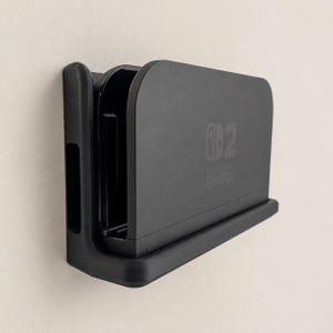 Soporte de pared PETG para base de Switch 2 – Soporte de fijación segura con tornillos (tornillos incluidos)