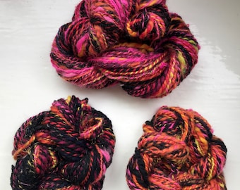 Handspun art yarn, hand carded tops, Firecracker- vivid pink, black, touch of orange, yellow and gold, chunky