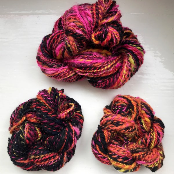 Handspun art yarn, hand carded tops, Firecracker- vivid pink, black, touch of orange, yellow and gold, chunky