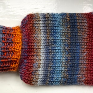 Mini hot water bottle and hand knitted lightly felted cozy, wool rich cover, mini 500ml, blended colours, reds, blues, glowing orange image 1