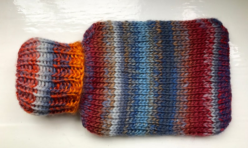 Mini hot water bottle and hand knitted lightly felted cozy, wool rich cover, mini 500ml, blended colours, reds, blues, glowing orange image 1