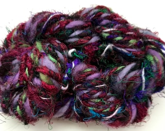 Handspun art yarn, sari silk, wool, curls, subtle gleam, dark purples, and reds by SpinningStreak