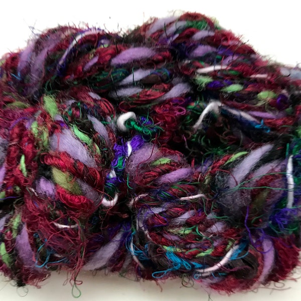 Handspun art yarn, sari silk, wool, curls, subtle gleam, dark purples, and reds by SpinningStreak