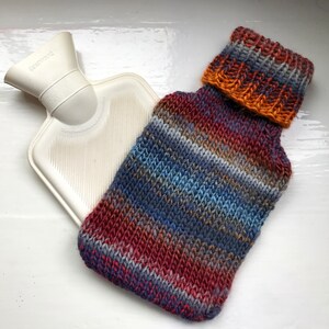 Mini hot water bottle and hand knitted lightly felted cozy, wool rich cover, mini 500ml, blended colours, reds, blues, glowing orange image 7