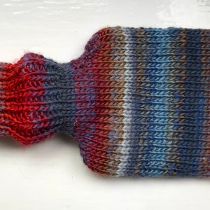 Mini hot water bottle and hand knitted lightly felted cozy, wool rich cover, mini 500ml, blended colours, reds, blues, glowing orange image 3