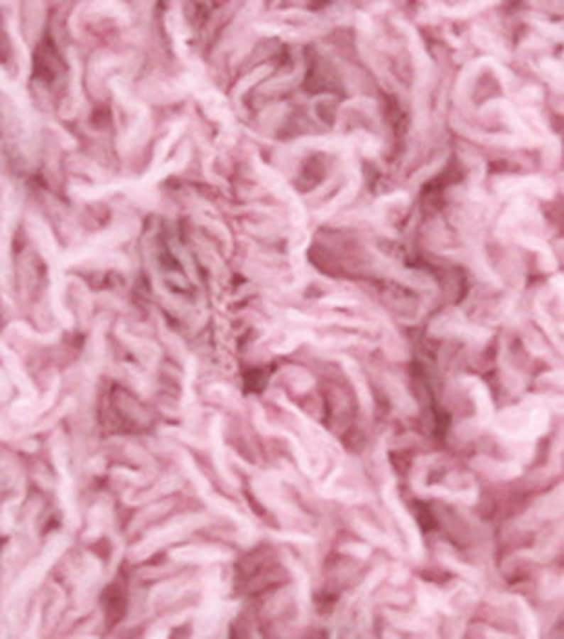 May include: A skein of soft, pink, fluffy yarn.