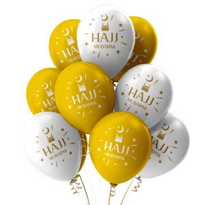 May include: A cluster of white and gold balloons. Each balloon has the words "HAJJ MUBARAK" printed in gold, along with a mosque and star design. The balloons are tied together with gold ribbon.