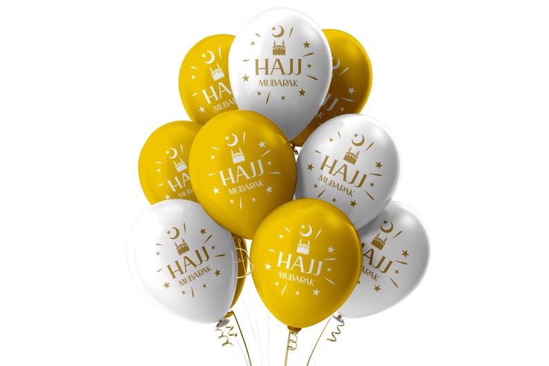 May include: A cluster of white and gold balloons. Each balloon has the words "HAJJ MUBARAK" printed in gold, along with a mosque and star design. The balloons are tied together with gold ribbon.