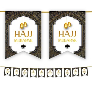 May include: Decorative banner set with a gold string. The banners feature a black and gold ornate design with the words "HAJJ MUBARAK" in gold. The design includes gold lanterns and an image of the Kaaba. A smaller banner with the same design is also included.