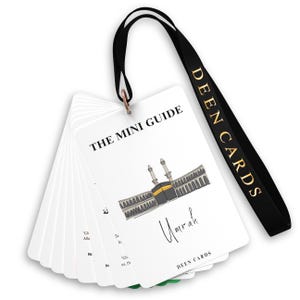 May include: A set of white mini guide cards with the title "THE MINI GUIDE" and the word "Umrah" in script. The cards feature an illustration of a religious building and are attached to a black lanyard with "DEEN CARDS" in gold lettering.