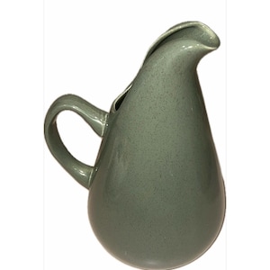May include: A green ceramic pitcher with a speckled finish and a wide, rounded spout. The pitcher has a handle and a teardrop shape.