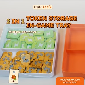 May include: A white 2-in-1 token storage in-game tray with an orange lid. The tray contains green and yellow tokens. The text on the image reads "CUBIC ROBIN", "2 IN 1 TOKEN STORAGE IN-GAME TRAY", "Multiple size/color", and "ROBICUBE MAKERS COLLECTION".