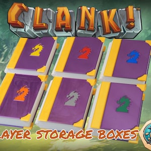 May include: Six purple and yellow storage boxes with different colored dragon symbols. The boxes are labeled "CLANK!" and "PLAYER STORAGE BOXES".