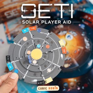 May include: A circular gray cardboard player aid for the SETI board game featuring a central yellow sun, orbiting planets labeled Mercury, Venus, Mars, Jupiter, Saturn, Uranus, and Neptune, and colorful rectangular markers along the outer edge.