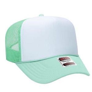 May include: A mint green and white trucker hat with a white front panel, mint green mesh back, and a curved brim. The hat has a rope detail and a tag that reads "World Famous Foam Trucker".
