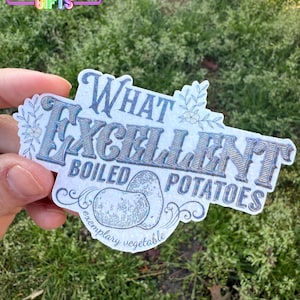 May include: A white sticker with a blue and silver holographic finish. The sticker features a stylized illustration of a potato with the text "What Excellent Boiled Potatoes" and "Exemplary Vegetable".