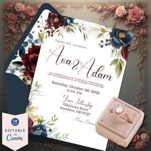 May include: Wedding invitation with floral accents in burgundy, navy, and green. The invitation includes the names "Ava & Adam", event details, and a rose gold engagement ring in a velvet box. The text reads "Editable in Canva."