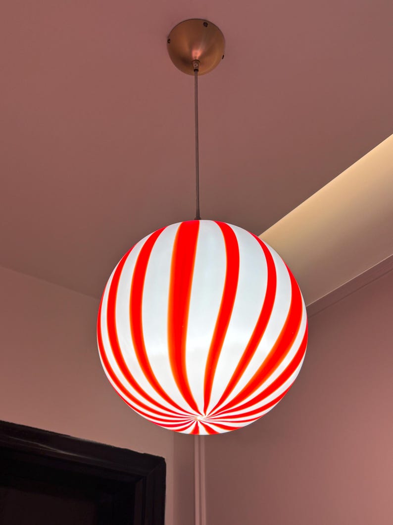 Hand blown glass globe pendant lights with red vertical strips for dinning room, kitchen island and living room lighting. Handmade glass globe ceiling lights in candy shape for modern lighting and home interior decoration. Glass globe chandelier.