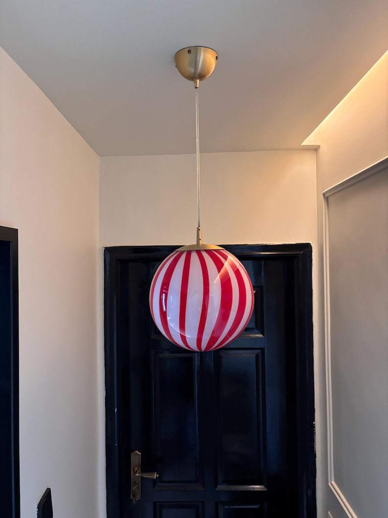 Hand blown glass globe pendant lights with red vertical strips for dinning room, kitchen island and living room lighting. Handmade glass globe ceiling lights in candy shape for modern lighting and home interior decoration. Glass globe chandelier.