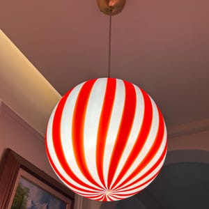 Hand blown glass globe pendant lights with red vertical strips for dinning room, kitchen island and living room lighting. Handmade glass globe ceiling lights in candy shape for modern lighting and home interior decoration. Glass globe chandelier.
