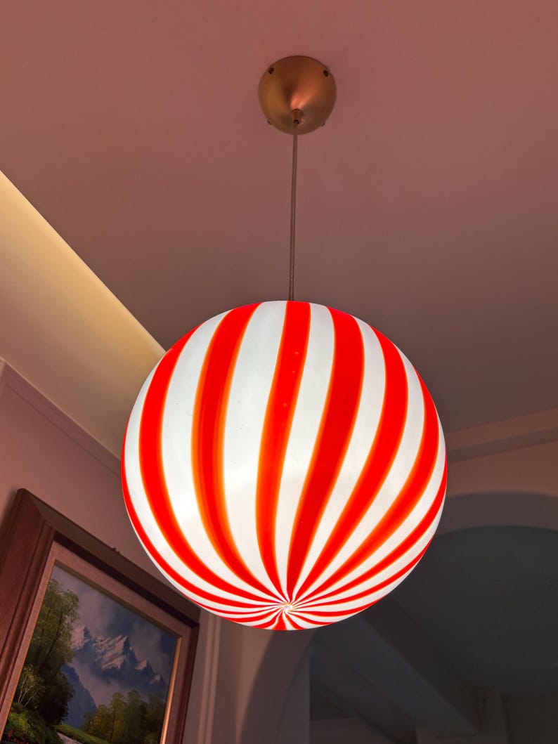 Hand blown glass globe pendant lights with red vertical strips for dinning room, kitchen island and living room lighting. Handmade glass globe ceiling lights in candy shape for modern lighting and home interior decoration. Glass globe chandelier.