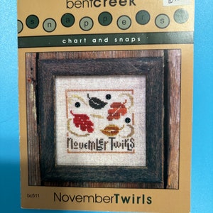 May include: Cross stitch pattern for a November themed design with the text "November Twirls" and a small image of leaves in shades of red, orange, and brown. The pattern is from Bent Creek, a company that sells cross stitch patterns and supplies.