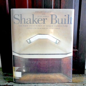 May include: A hardcover book titled "Shaker Built" with the subtitle "The Form and Function of Shaker Architecture." The cover features an architectural interior with a skylight. The book is edited and designed by David Larkin.